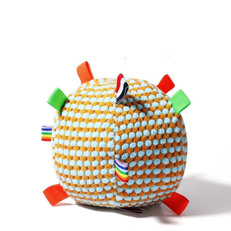 Blue and yellow vocal ball dog toy ring with pineapple texture, 17cm in diameter, on a green grass background.