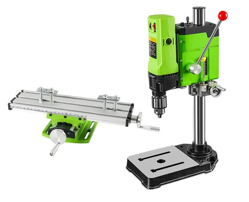 Mini bench drill and milling machine with heavy duty bench pliers on a workbench.