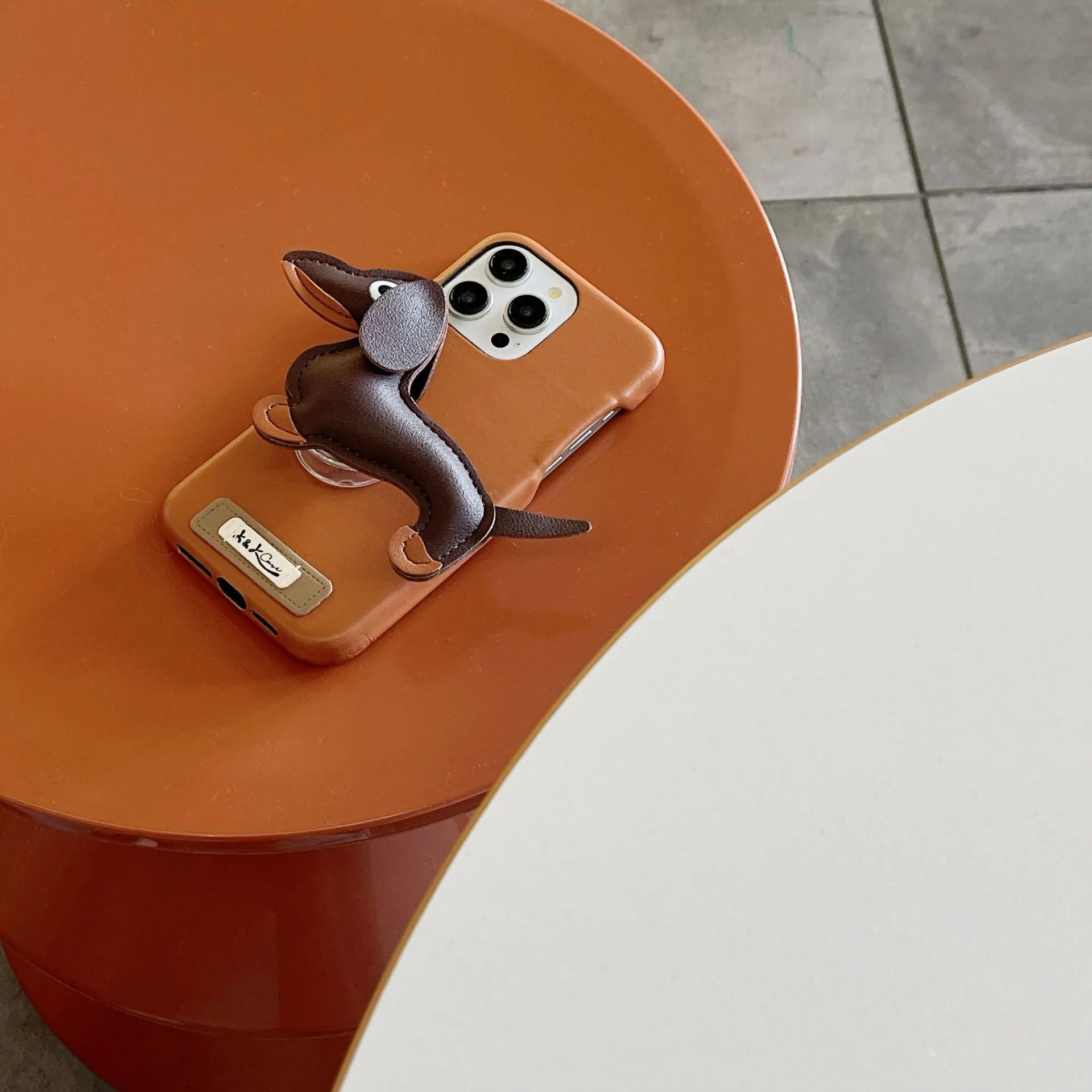 Sausage dog bracket phone case with imitation leather finish in black shell, compatible with iPhone models