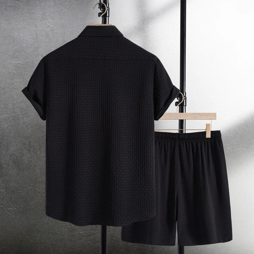 Men's black cotton blend beach suit with loose cardigan shirt and matching shorts.