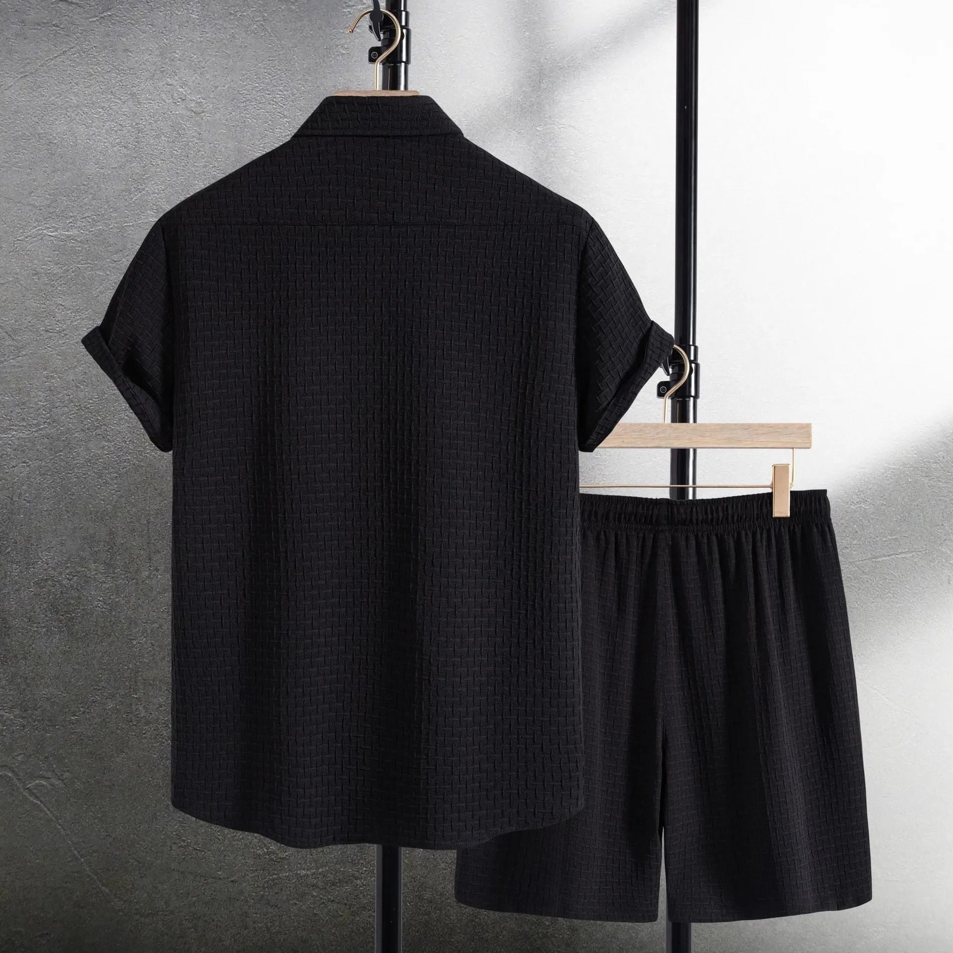 Men's black cotton blend beach suit with loose cardigan shirt and matching shorts.