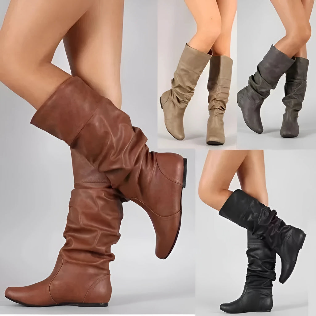 Women's black slip-on knee-high flat boots with a round toe and rubber sole.