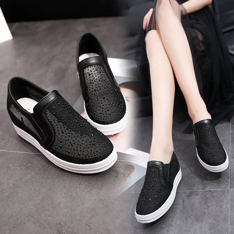 Women's wedge slip-on shoes with mesh upper in black colour showing rubber sole