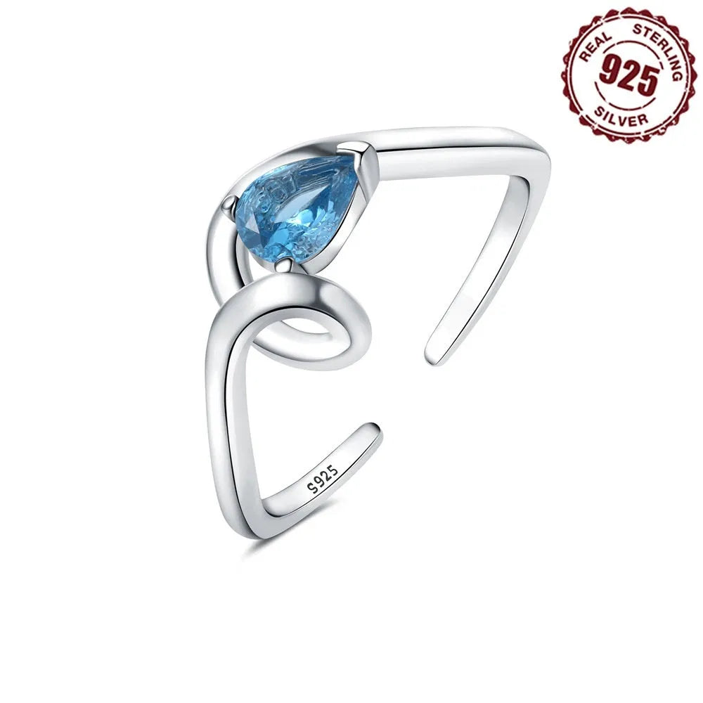 S925 sterling silver open-end ring with curve inlaid blue zircon stone and fold design on a white background