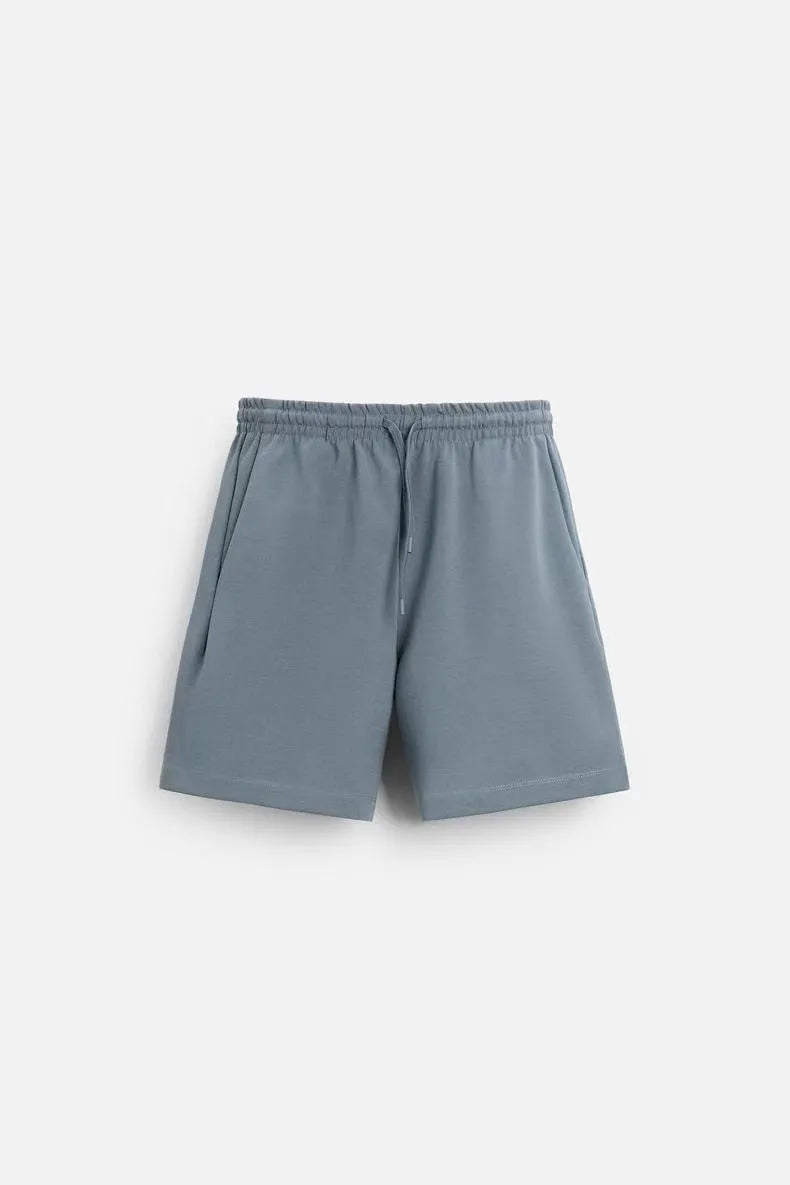 Loose blue polyester short sleeve top and matching shorts set on a hanger.