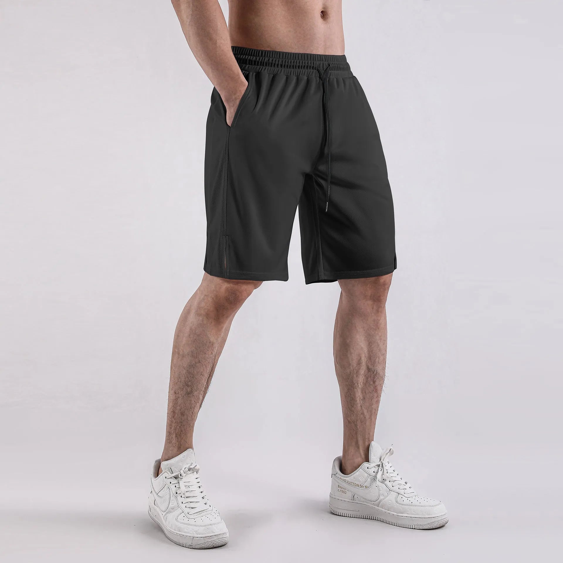 Men's black quick-dry mesh capri shorts with an elastic waistband, shown in a loose, casual fit.