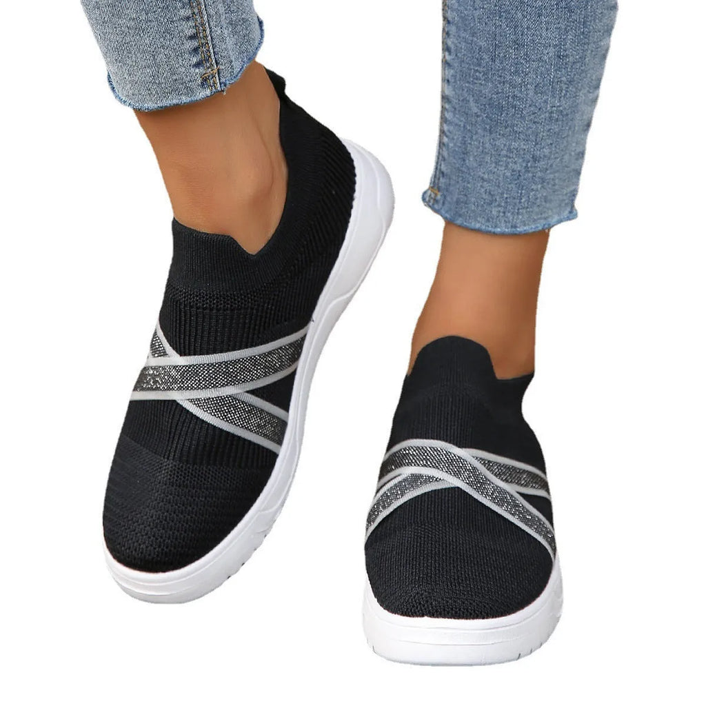 Black women's flyknit mesh shoes with flat rubber sole and tassel detail