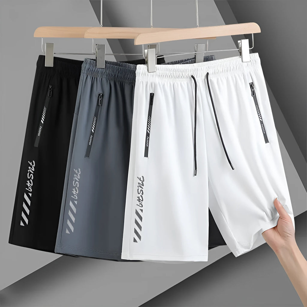 Men's black quick-dry loose-fit nylon sports shorts on a size chart background