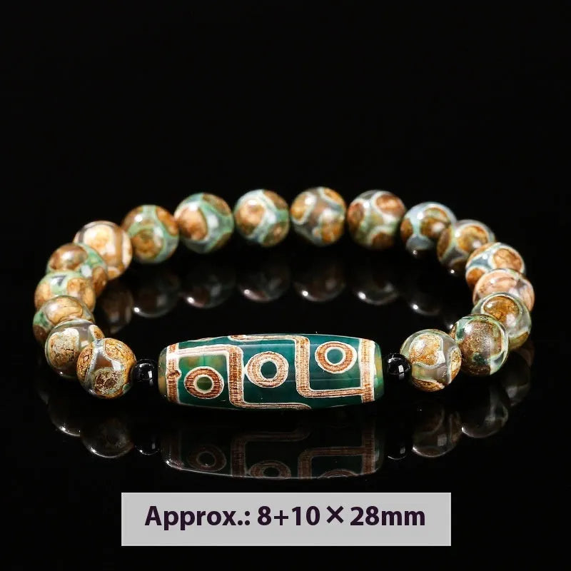 Handmade green dzi bead barrel bracelet with 8mm round geometric beads on a wrist.