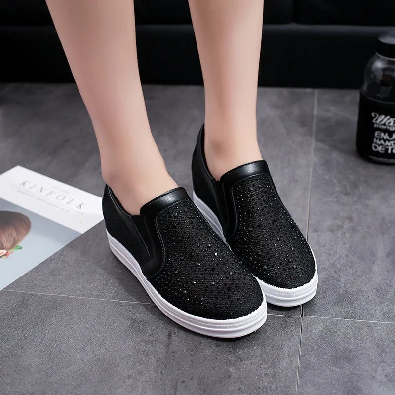 Women's wedge slip-on shoes with mesh upper in black colour showing rubber sole