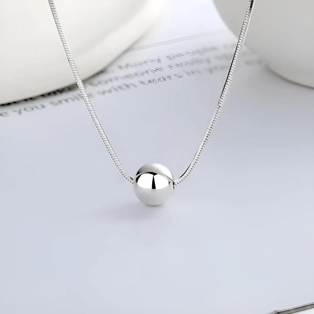 Silver necklace with small ball pendants on delicate chain for clavicle wear