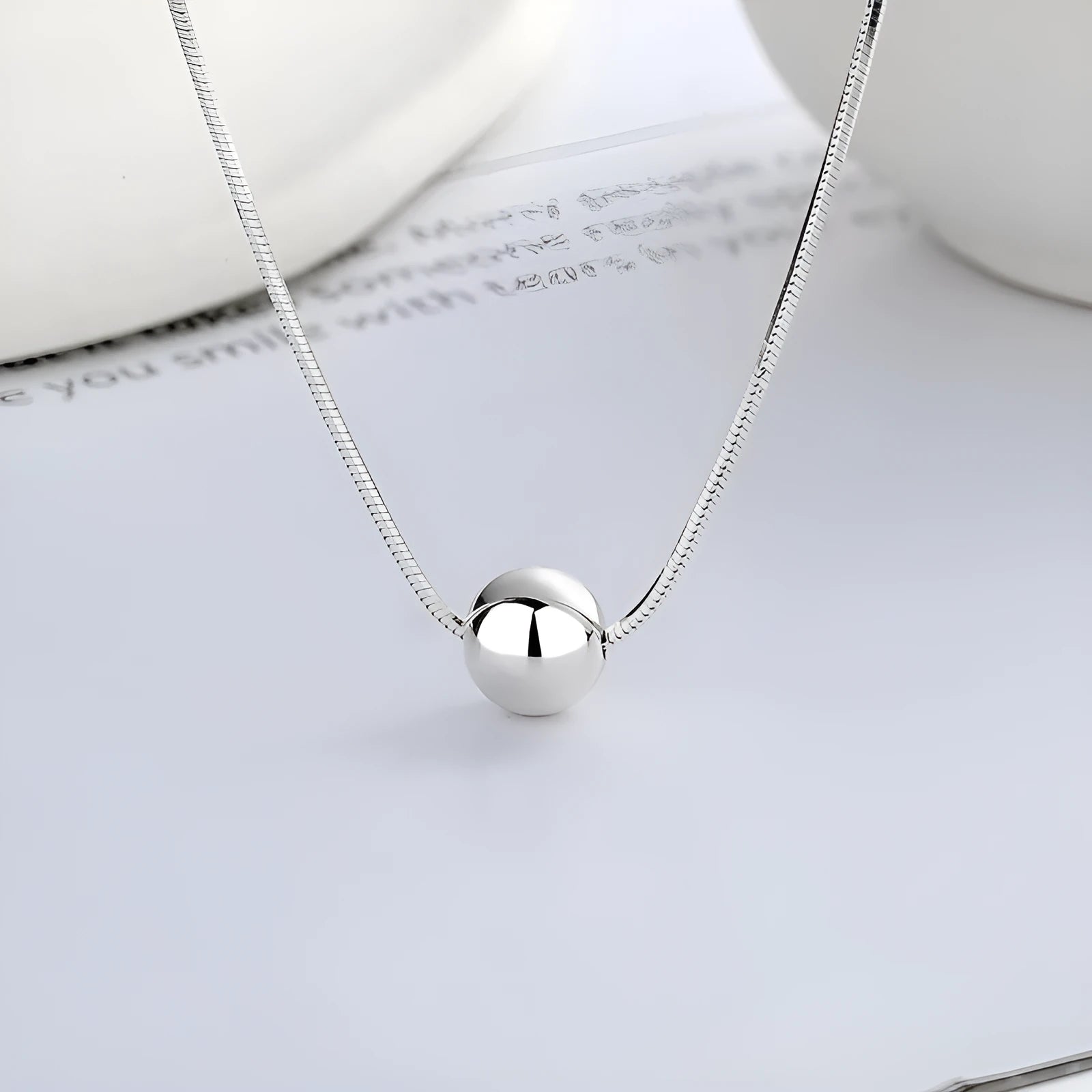 Silver necklace with small ball pendants on delicate chain for clavicle wear