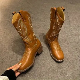 Brown women's mid-calf boots with embroidered pattern, round toe, and low square heel on a rubber sole.