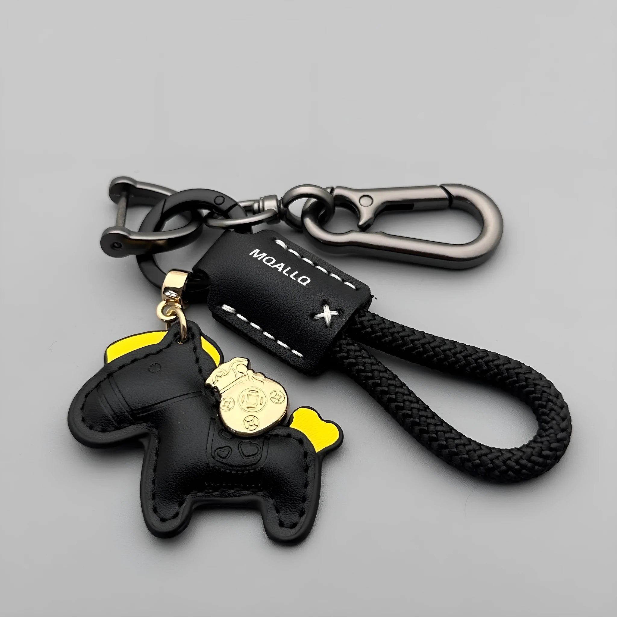 Handmade brown cowhide leather key ring with a zinc alloy pendant charm on a green flannel rope.