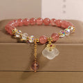 Women's adjustable crystal bracelet with strawberry quartz and white agate beads featuring auspicious cloud charm