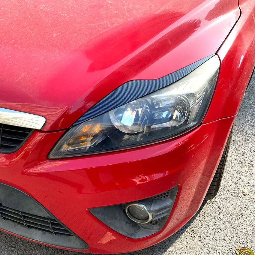 Ford Focus headlight eyebrow stickers in carbon fibre pattern or piano black ABS plastic