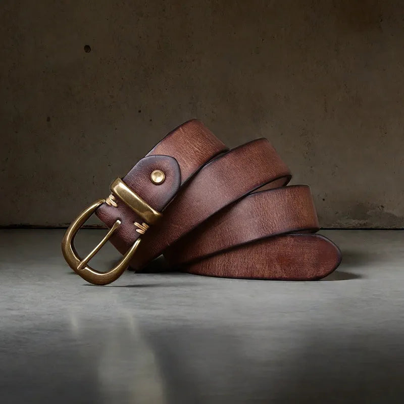 Men's brown casual leather belt with a copper pin buckle shown on a pair of jeans