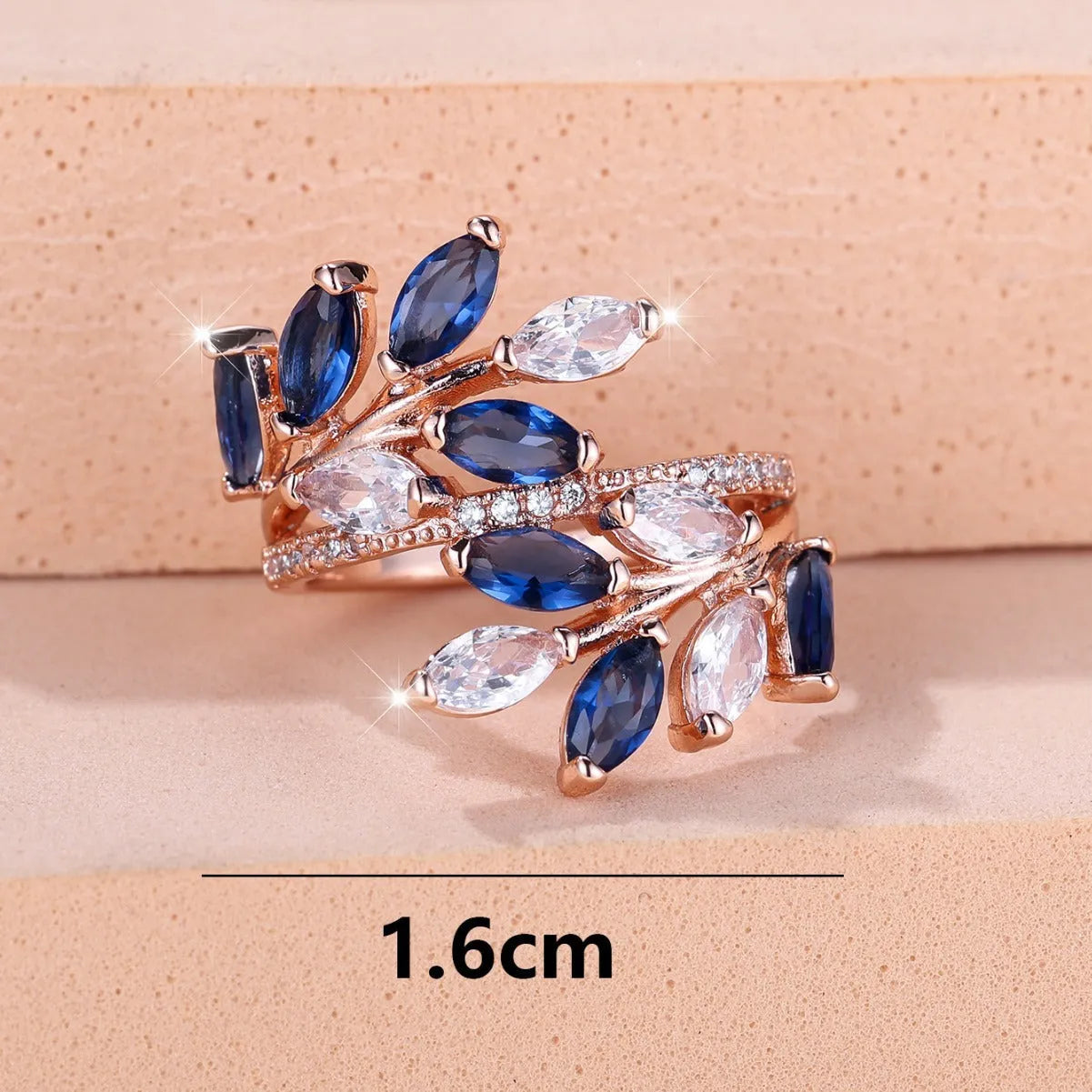 Adjustable copper leaf ring with a central zircon stone on a finger, showing rose gold and platinum colour options.
