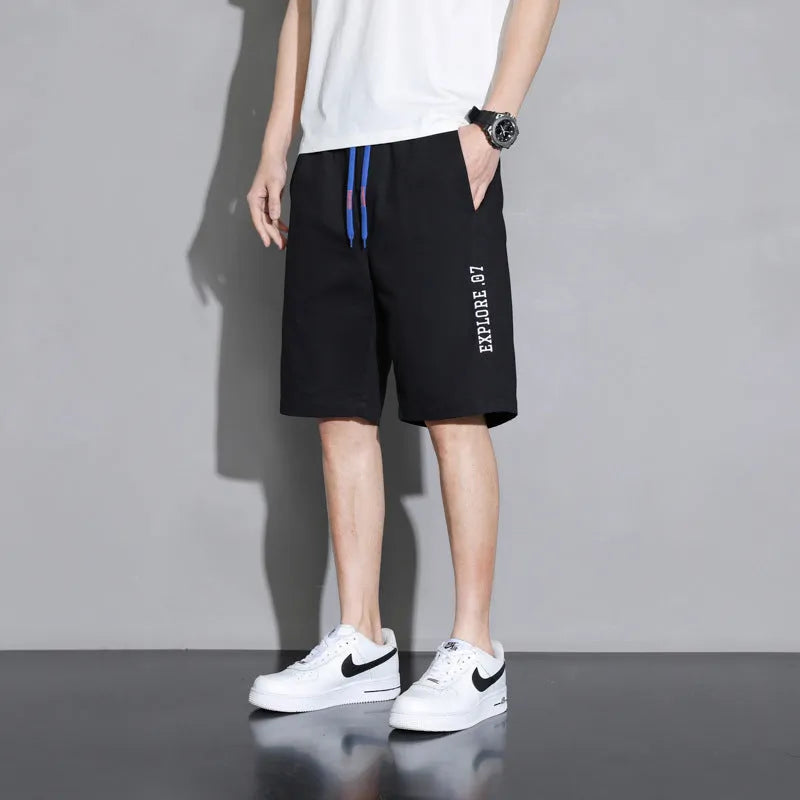 Boys' cotton shorts in black, khaki, or white, showing mid-waist and shorts length design.