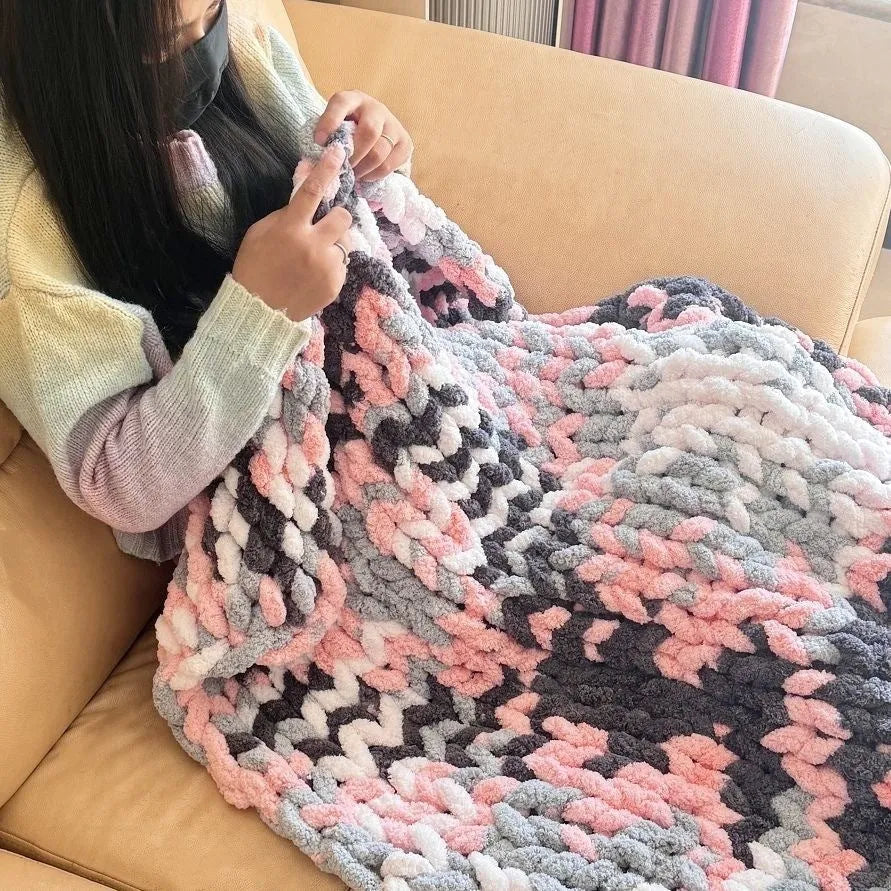Coarse yarn chenille knitted blanket with braided gravity detail in modern colour option