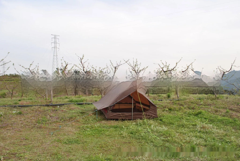 Brown and white pole-free A-line cabin tent for 2-3 people shown pitched with hiking poles.