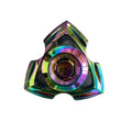 Silver and colourful alloy fingertip gyro decompression fidget toy on a plain background.