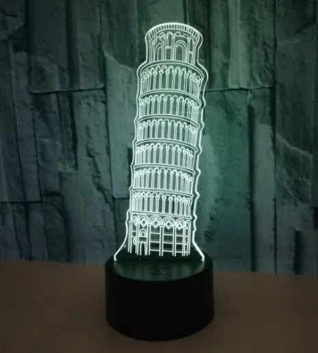 3D laser-cut Leaning Tower of Pisa nightlight glowing blue on a black base with a remote control.
