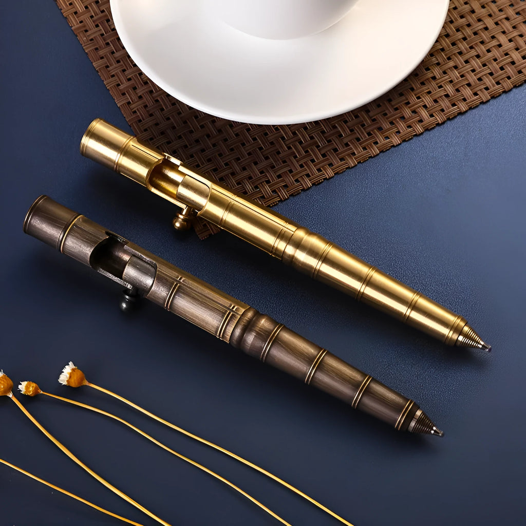 Retro brass tactical pen showing press bolt mechanism and cylindrical barrel in natural brass finish.