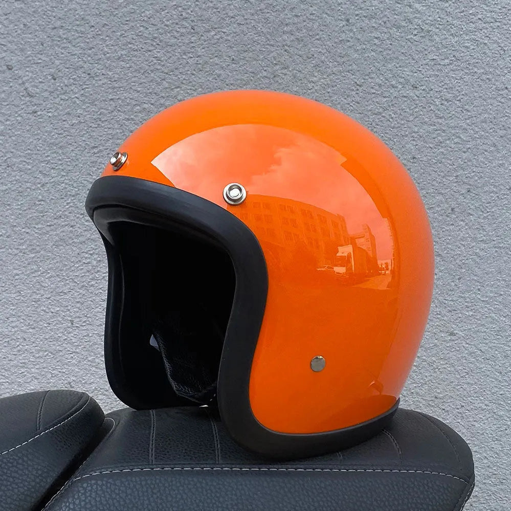 Retro-style open-face motorcycle helmet in fibreglass, shown in a choice of colours including Cement Grey and Matte Black Flower.