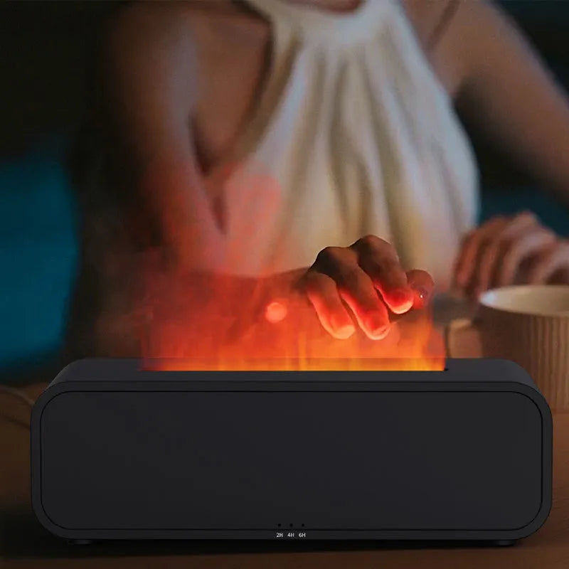 Black and white aromatherapy diffuser with flame LED effect and remote control on wooden surface