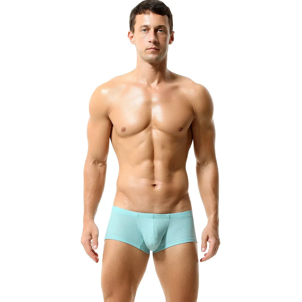Solid colour low waist men's boxers in nylon fabric on a white background