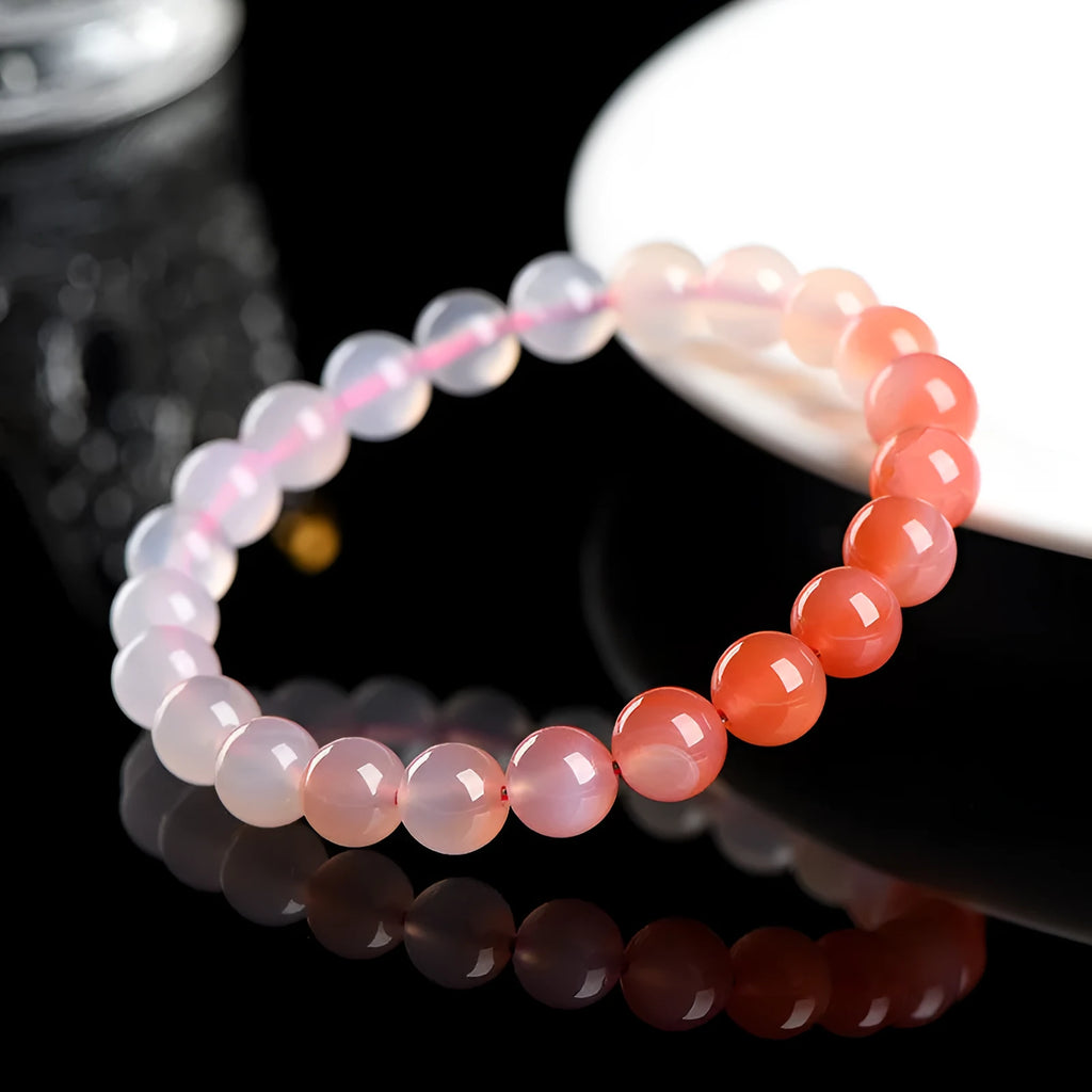 Natural gradient salt source colour Yanyuan agate bracelet with geometric beads on a wrist.