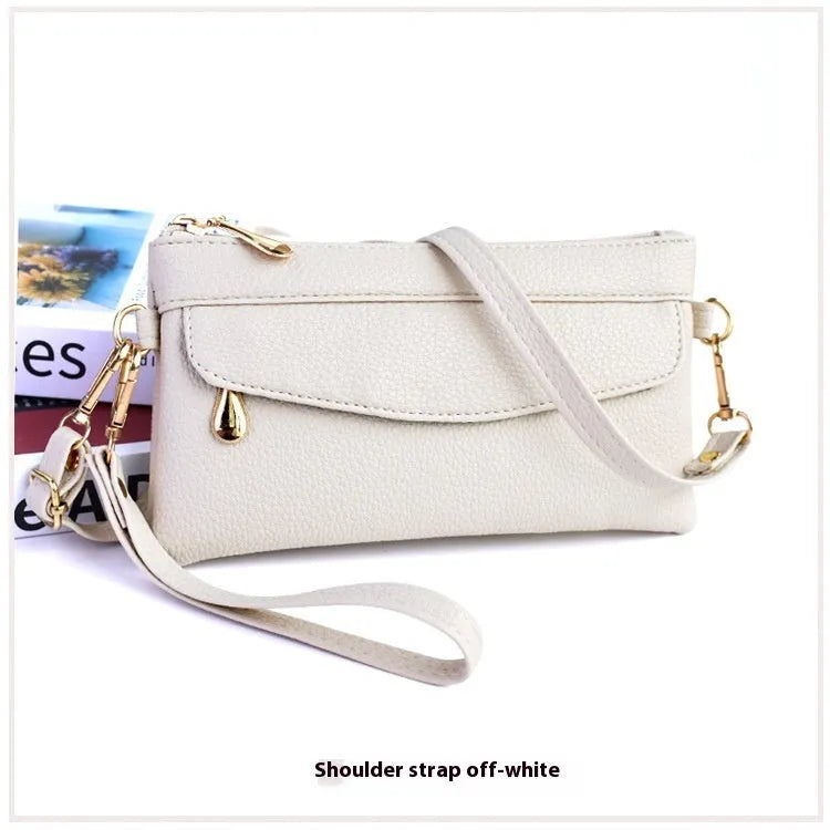 Soft PU leather crossbody bag in a square shape showing the internal sandwich zipper pocket.