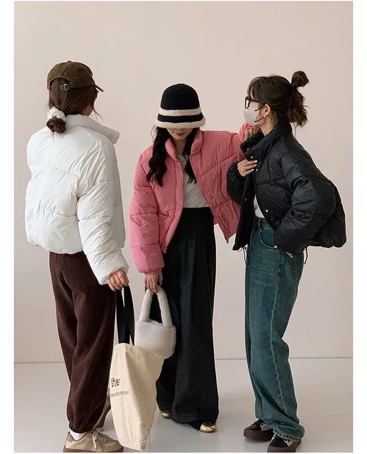 Women's loose thick polyester padded coat with zip front, available in seven solid colours and sizes S to L