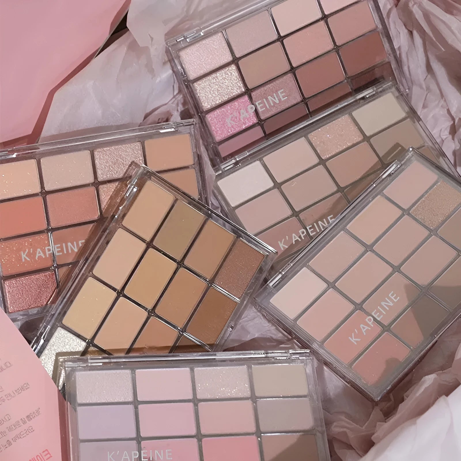 16-colour eye shadow palette showing matte and shimmer finishes in pink, brown and neutral tones.