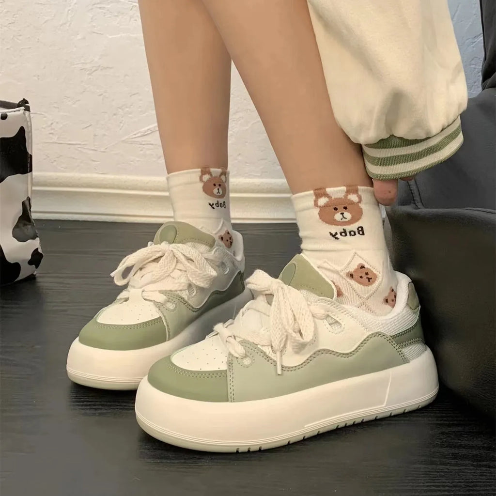 Green women's casual shoes with round toe, flat heel, and breathable mesh upper.