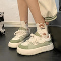 Green women's casual shoes with round toe, flat heel, and breathable mesh upper.