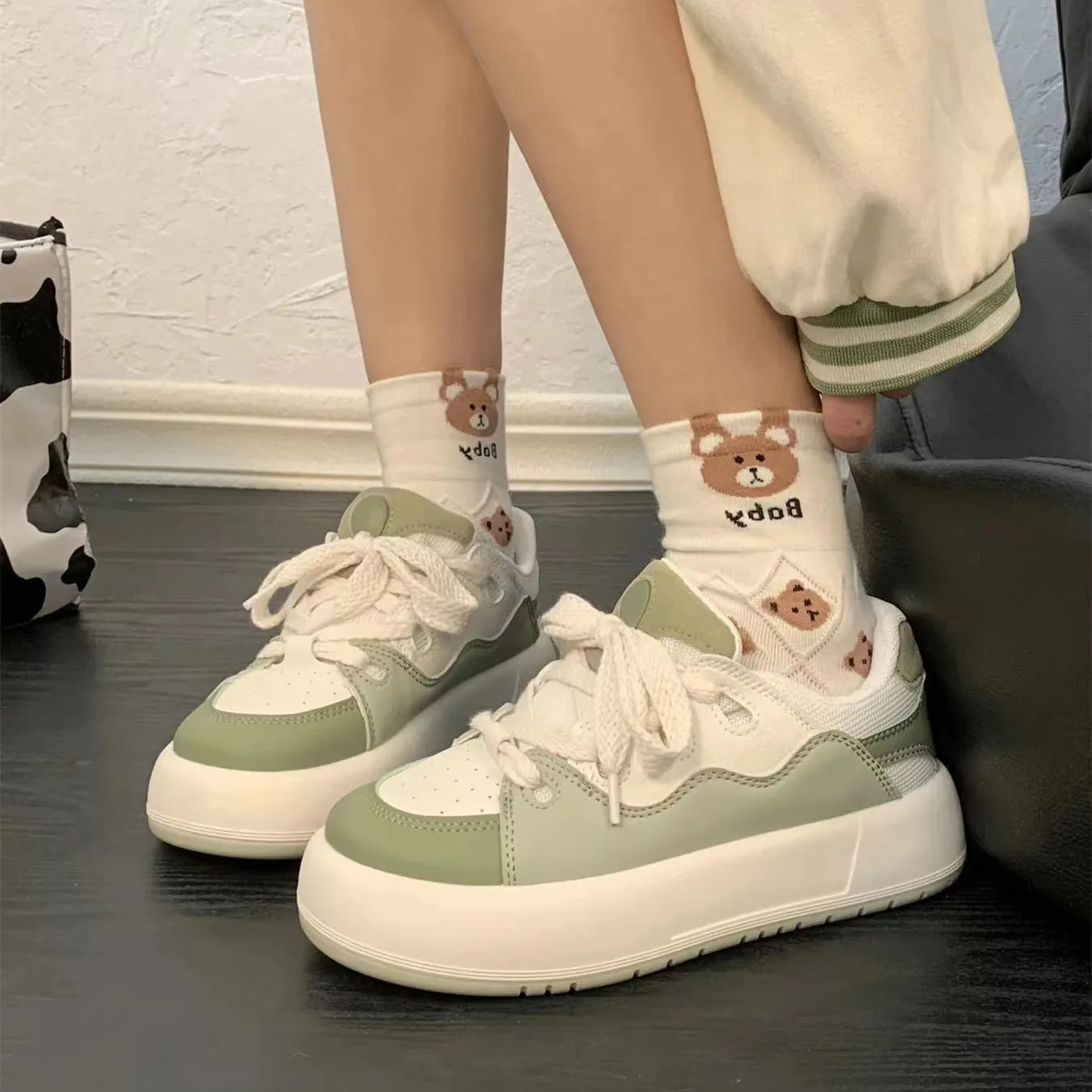 Green women's casual shoes with round toe, flat heel, and breathable mesh upper.