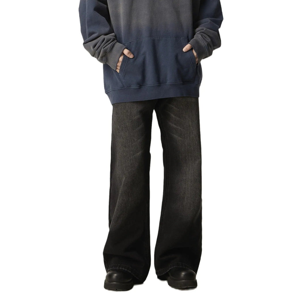 Black loose straight-leg jeans with a retro light wash and zip fly closure laid flat.