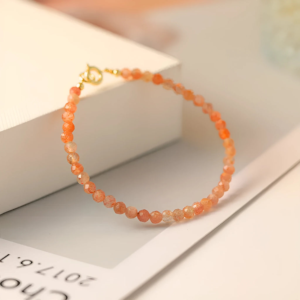 Ultra-thin 3mm sunstone crystal bracelet shown on wrist with natural colour variations