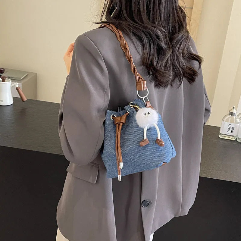 Blue one-shoulder cross body bucket bag with synthetic leather lining and sandwich pocket