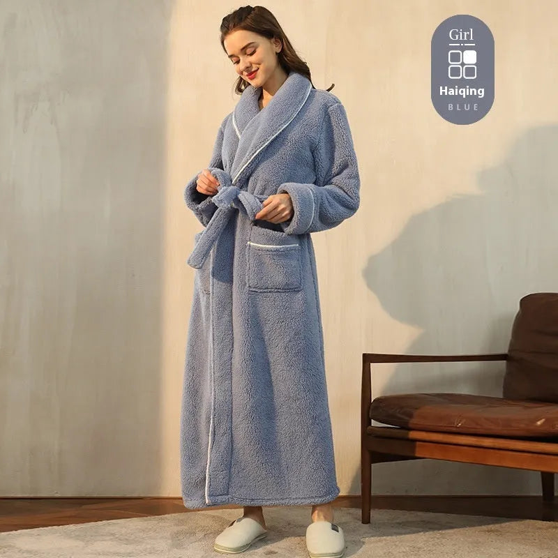 A man and woman wearing matching thick, navy blue flannel bathrobes in a European style cut.
