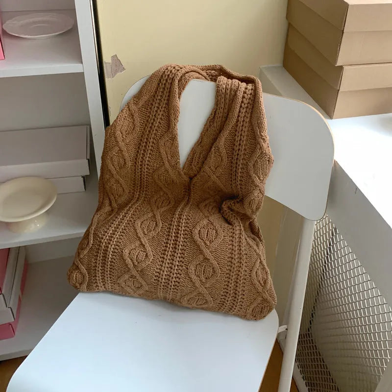 GWomen retro crochet shoulder tote bag in a solid colour, showing knitted texture and double strap connectors.