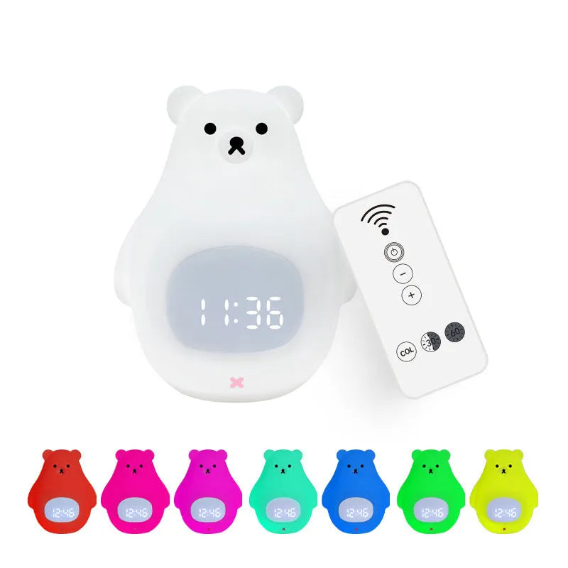 White silicone bear-shaped night light with remote control on a bedside table.