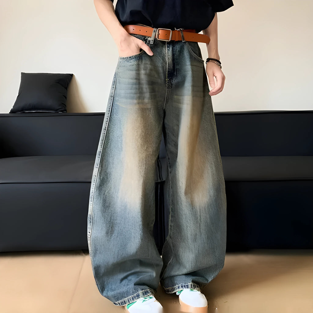 Man wearing Retro Blue distressed wide-leg denim jeans with a slimming silhouette and mid-waist fit.