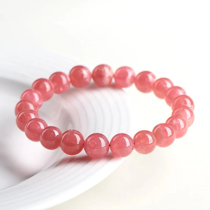 Women's geometric crystal bracelet with a longevity lock, shown in rhodochrosite colours.