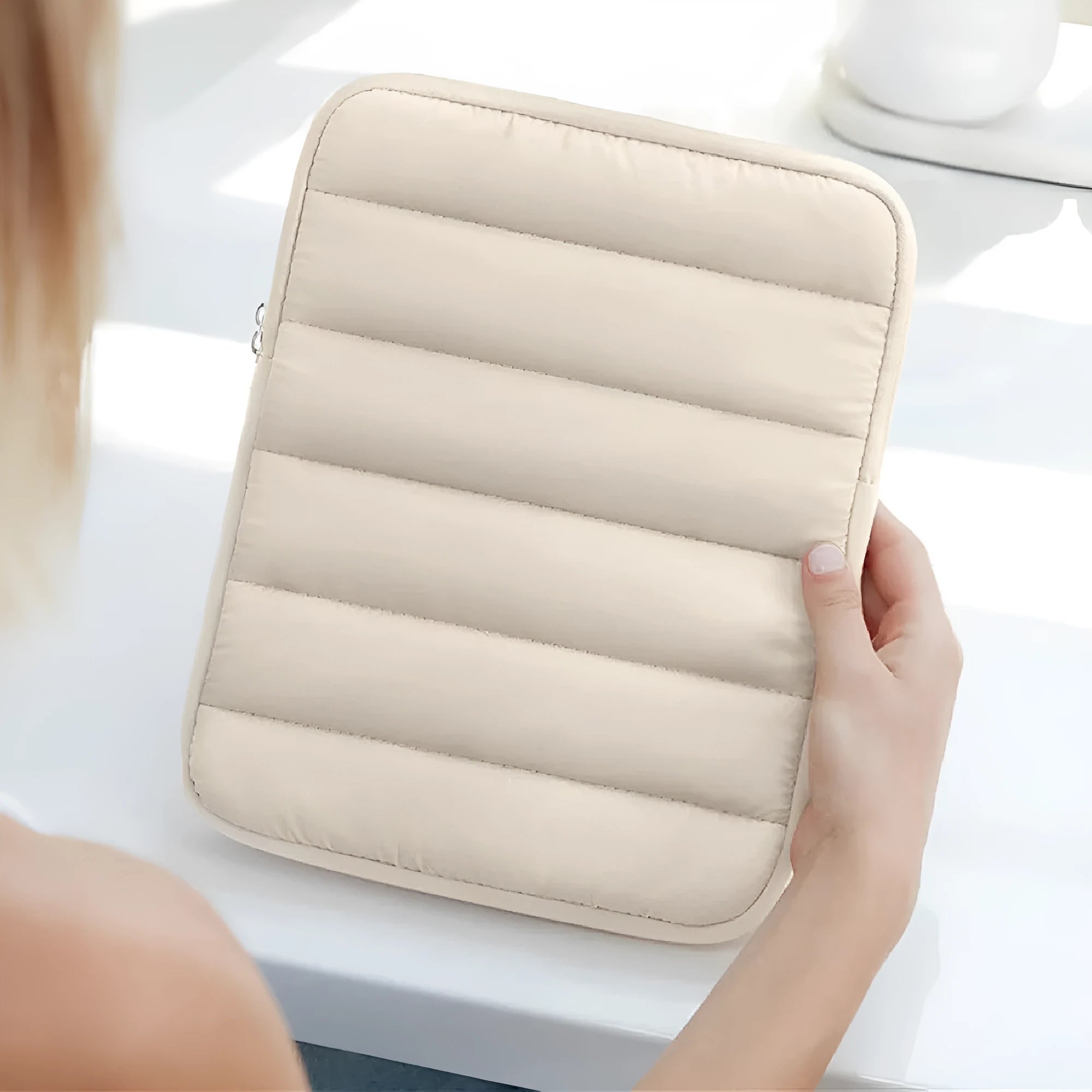 Black puff bag laptop sleeve with elastic sides for a 9.7 to 11 inch MacBook.