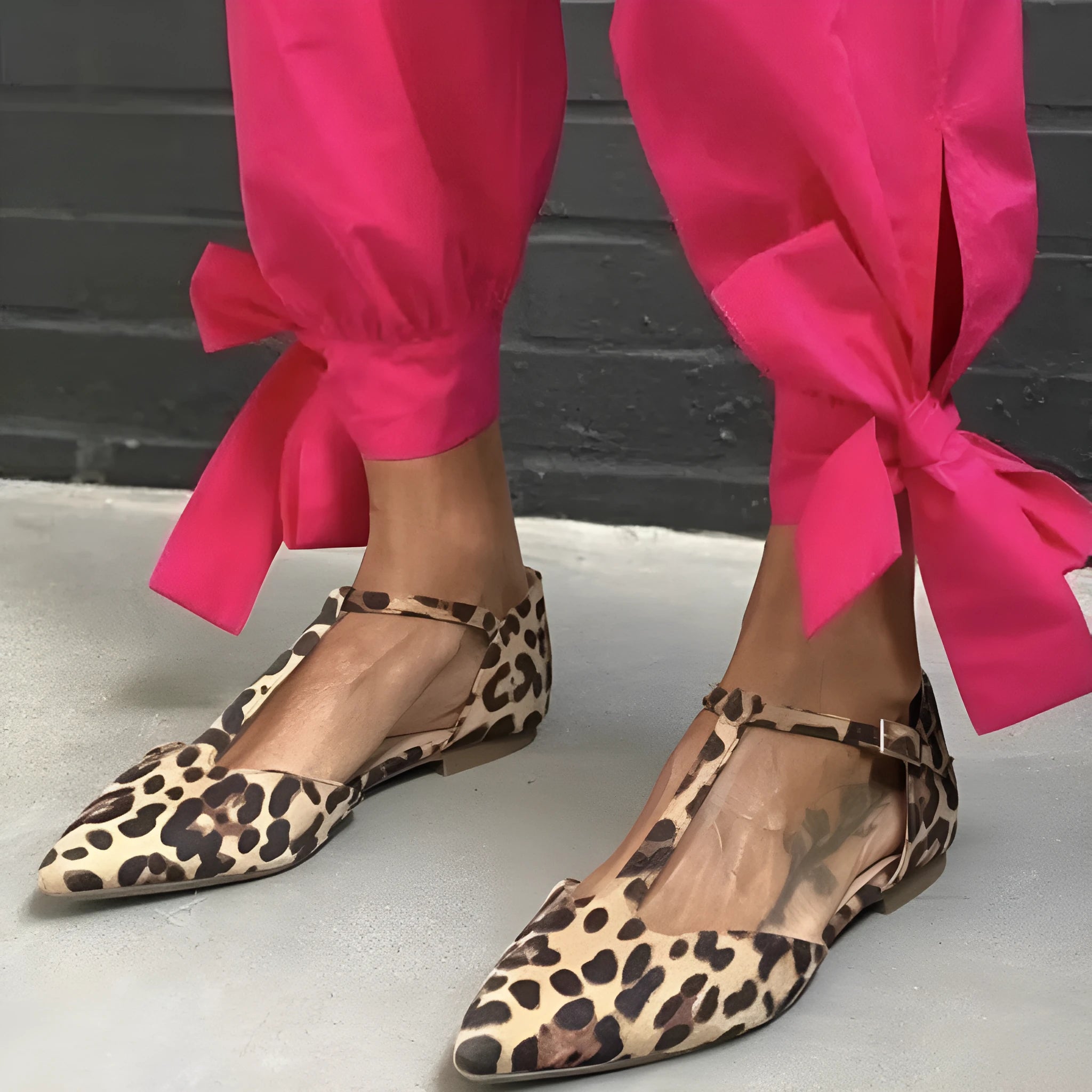 Leopard print women's pointed toe pumps with a low chunky heel and an ankle cross-strap.