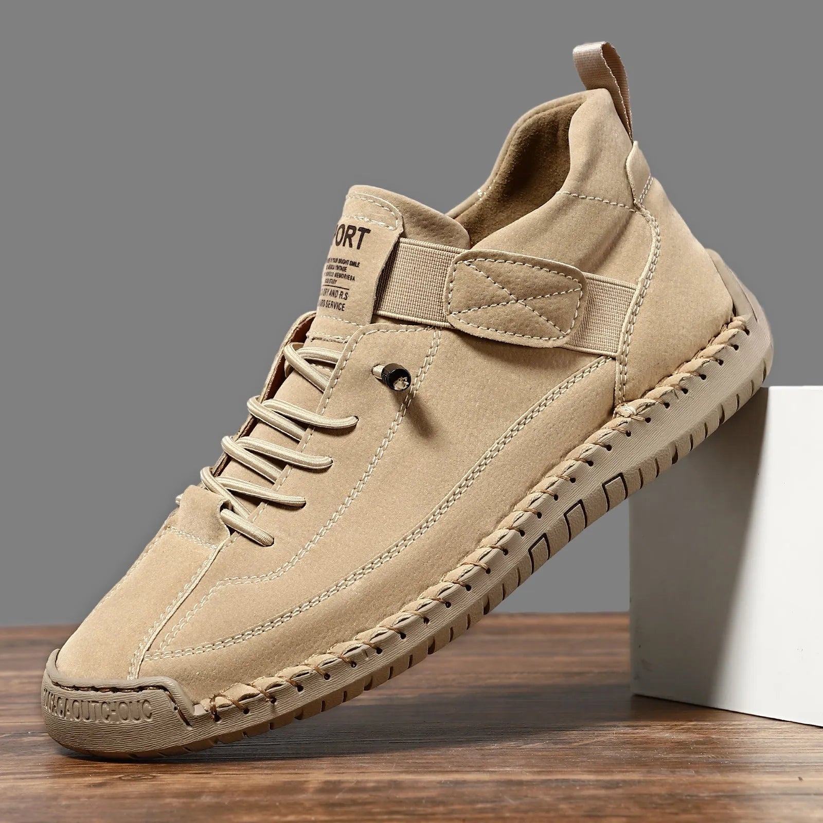 Men's mid-calf Martin boots in khaki with visible tooling stitching and an elastic band across the instep.