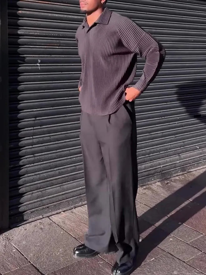 Man wearing a black pleated long-sleeved casual polyester top.